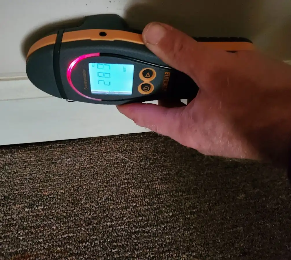 Moisture detection at baseboard during Storm Damage Restoration in Ocala